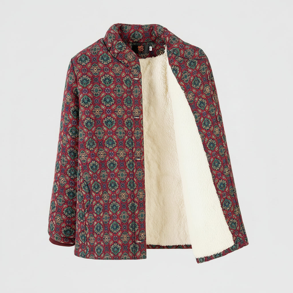 A women's quilted jacket with a red, green, and beige geometric pattern, featuring a soft cream fleece lining, shown on a hanger against a white background.