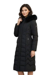 A woman modeling a long black quilted puffer coat with a black faux-fur trimmed hood, shown against a plain white background.