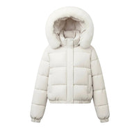 A cream-colored puffer jacket with a fluffy faux-fur trimmed hood, hanging on a wooden hanger against a light gray wall.