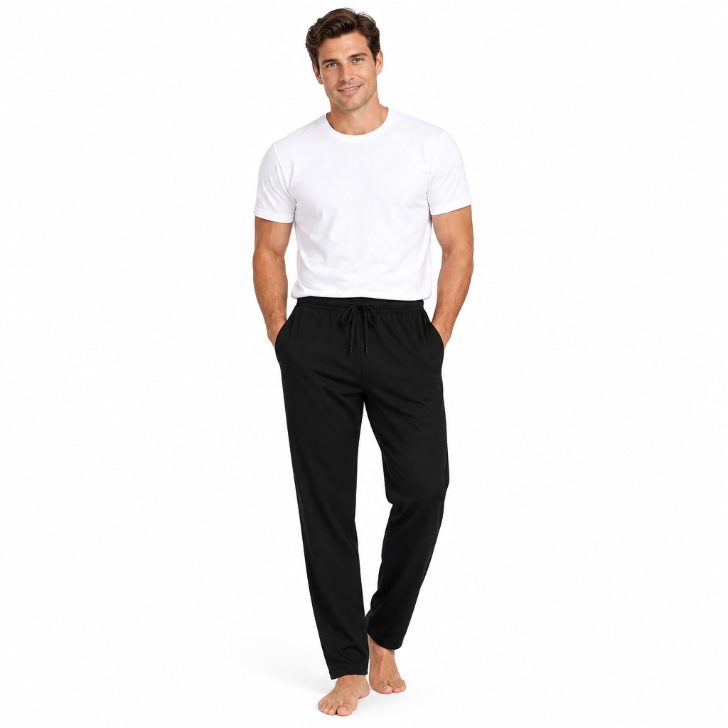 A man modeling a white crew-neck t-shirt and black drawstring sweatpants against a plain white background.
