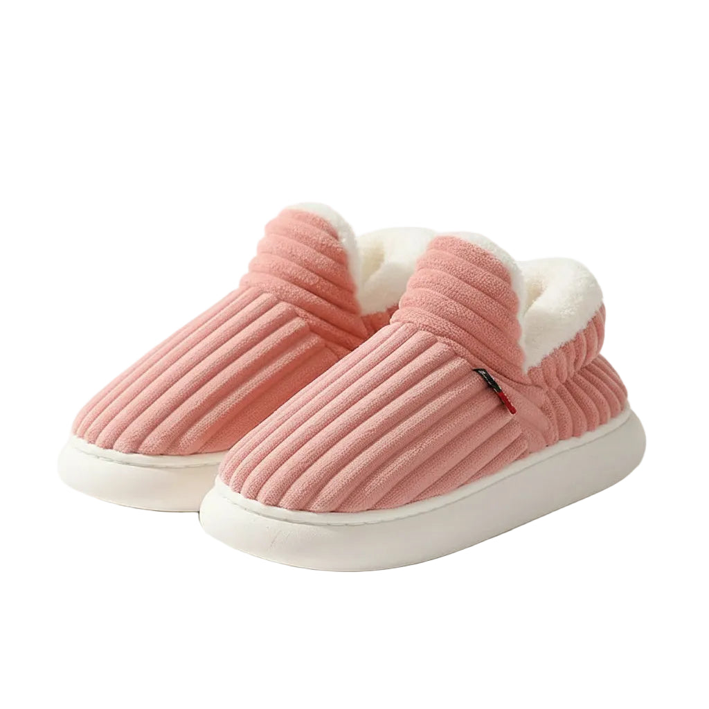 Pink slippers with white fur lining on a light surface