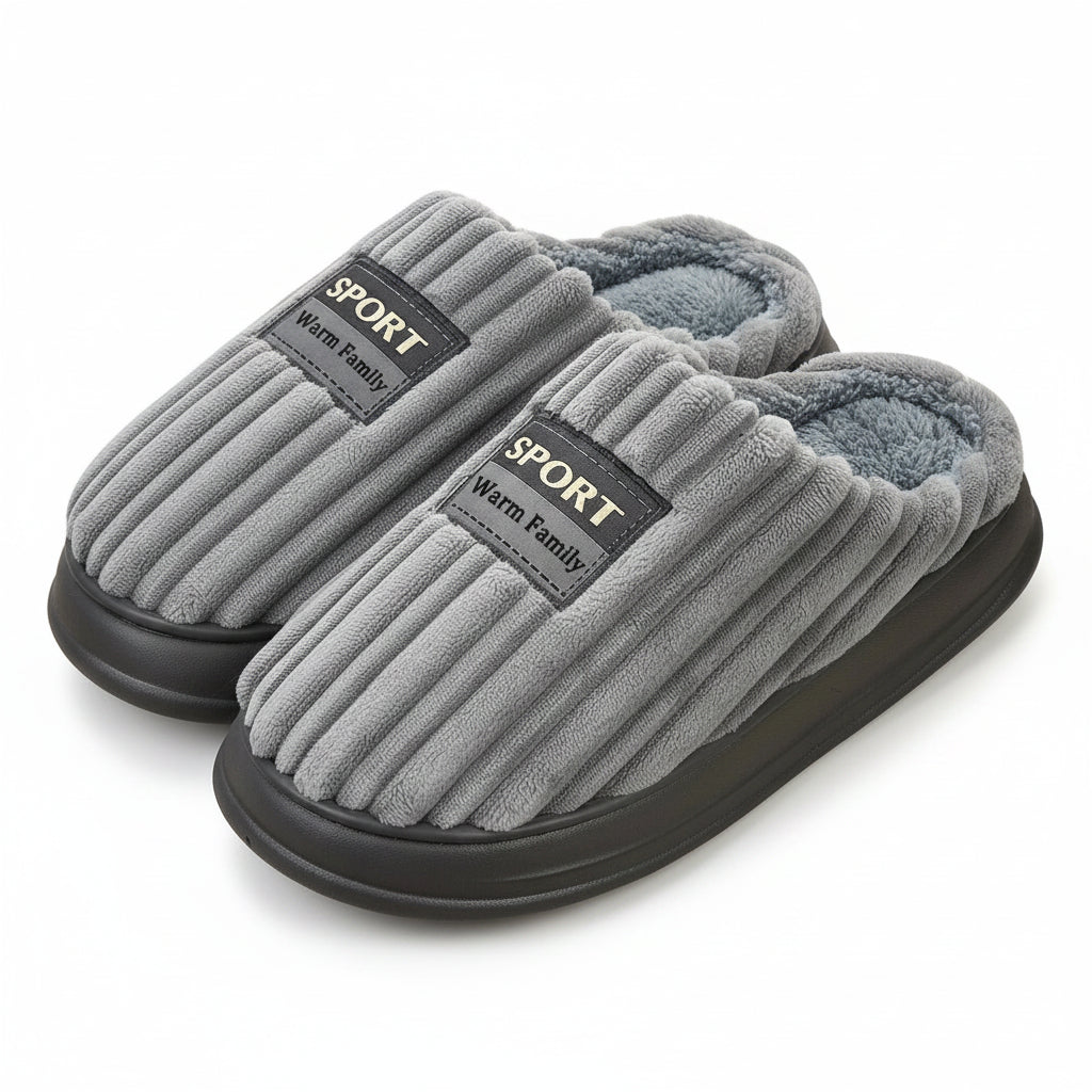 Gray slippers with 'Sport Warm Family' label on a wooden floor.
