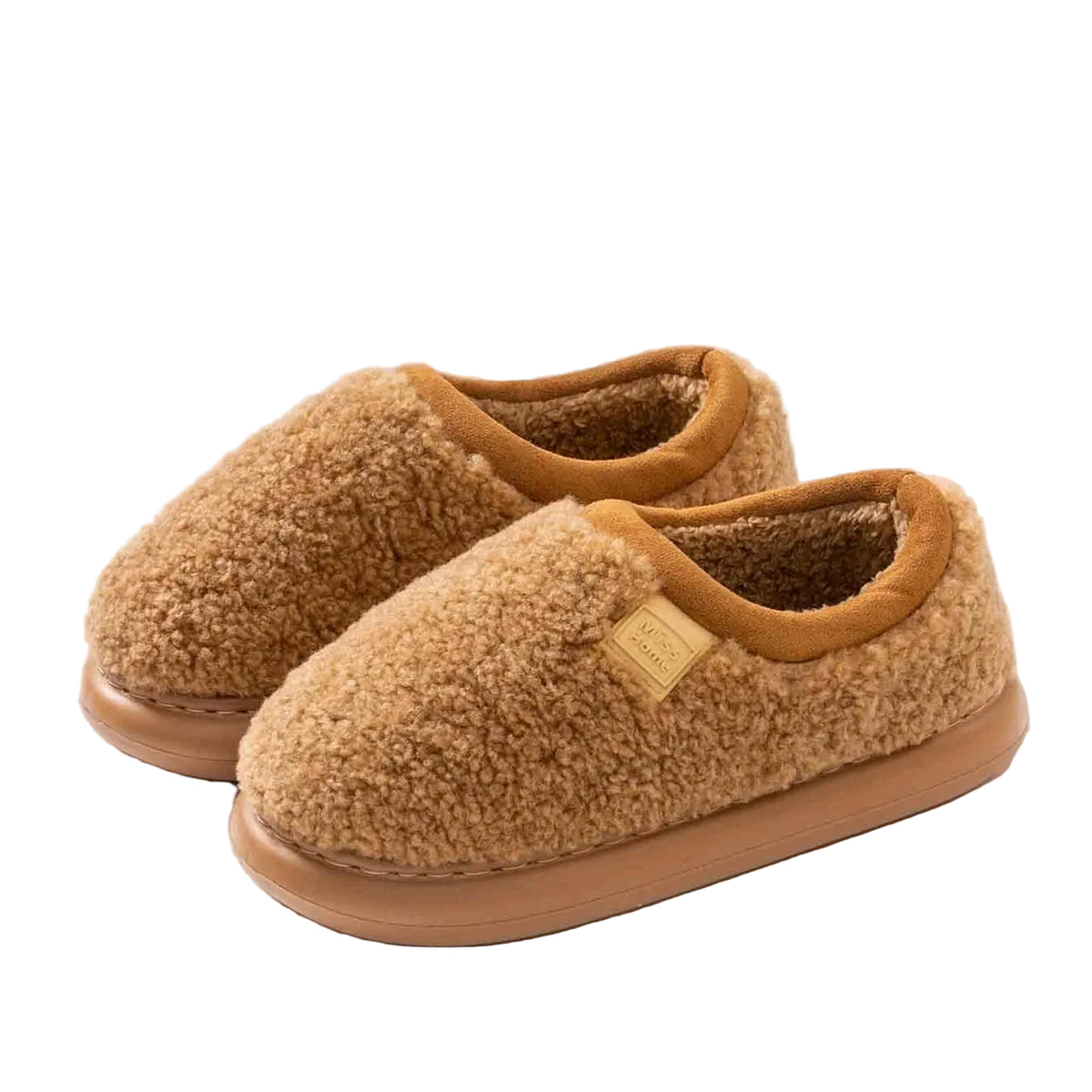 A pair of tan sherpa fleece slip-on slippers with a soft brown lining and sole, displayed on a solid beige background.