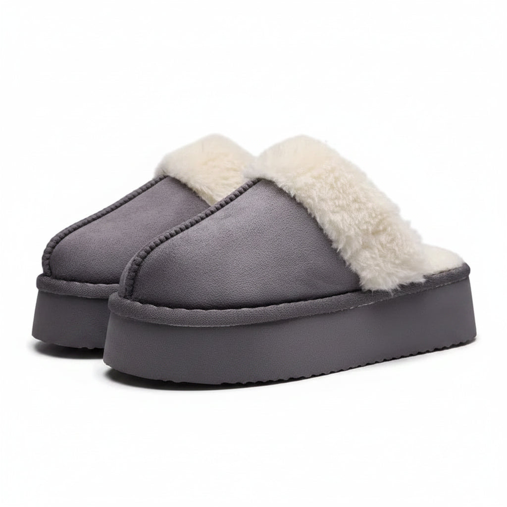 Gray slippers with white fur lining on a light gray background