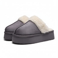 Gray slippers with white fur lining on a light gray background