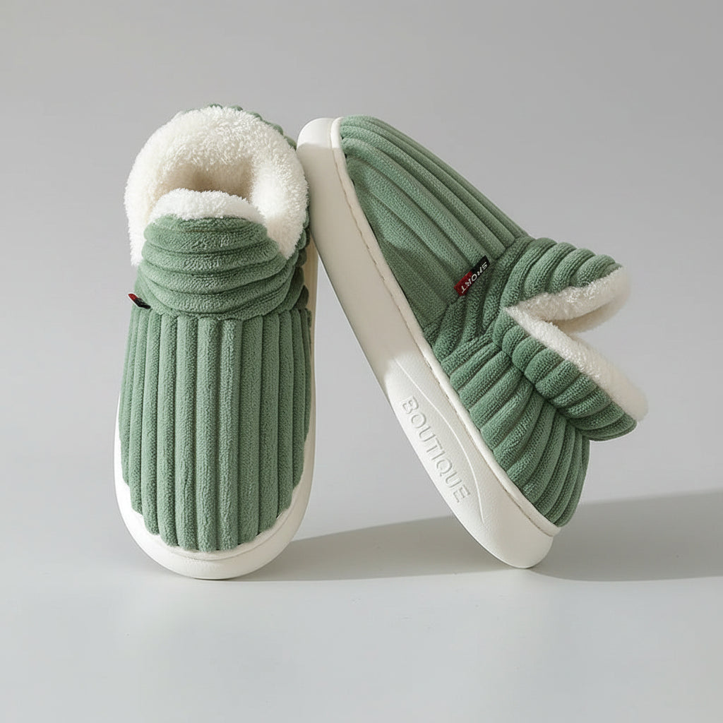 Green slippers with white fur lining on a light background