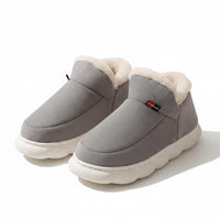 Gray slippers with white fur lining on a beige background