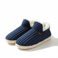 Blue slippers with white fur lining on a light-colored surface