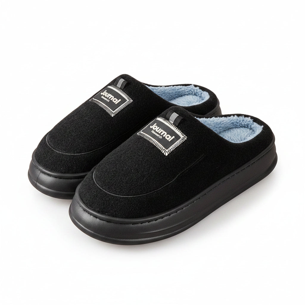 Black slippers with blue lining on a wooden floor