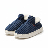 Blue slippers with white fur lining on a light-colored surface