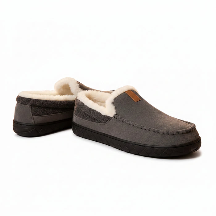 Gray slippers with white fur trim worn indoors on a carpeted floor.