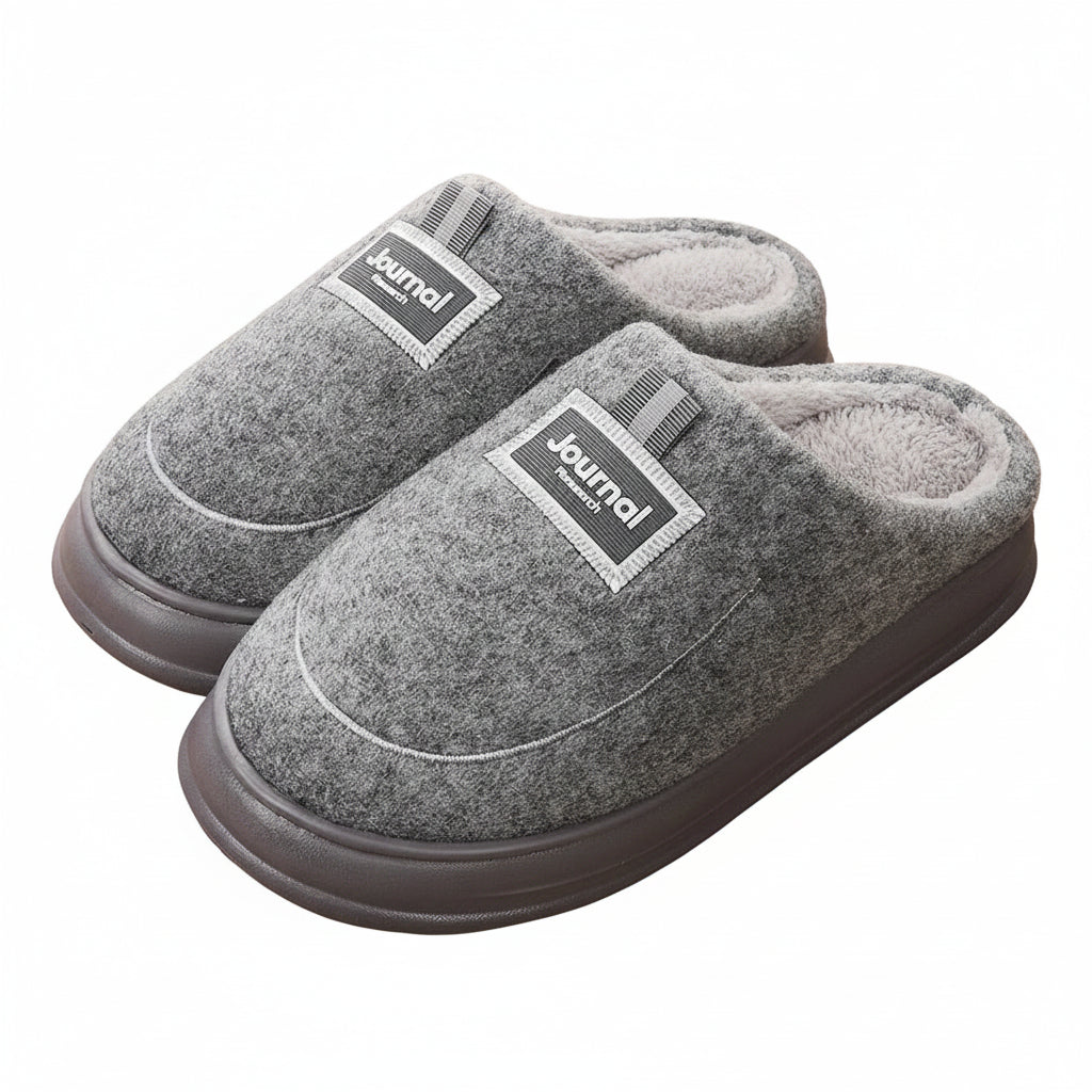Gray slippers with 'Journal' label on a wooden floor