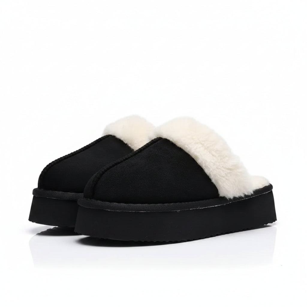 Black slippers with white fur lining on a light gray background