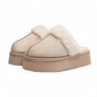Beige slippers with white fur lining on a light gray background