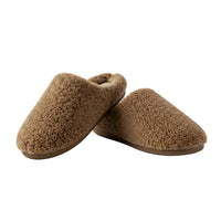 Pair of brown slippers on a beige background