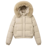 A beige puffer jacket with a large fluffy faux-fur trimmed hood, hanging on a wooden hanger against a light gray wall.