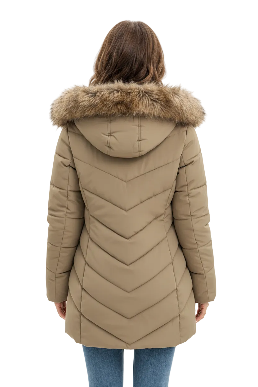 A woman viewed from the back wearing a beige puffer coat with a fur-trimmed hood and chevron quilting, paired with blue jeans against a plain light background.
