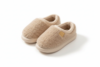 A pair of beige sherpa fleece slip-on slippers with a small tan brand tag on the side, displayed on a clean white background.