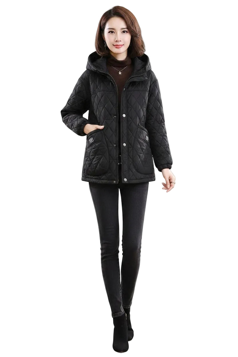 A woman modeling a black quilted winter jacket with a hood, front zipper, and snap buttons, paired with black leggings and black ankle boots, against a plain white background.