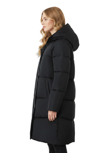A woman wearing a long black hooded puffer coat, shown in profile against a plain white studio background.
