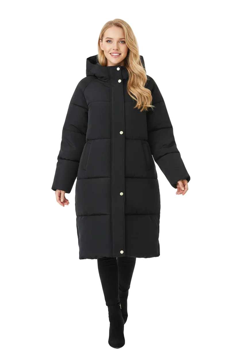 A woman modeling a long black hooded puffer coat with horizontal quilting and gold-tone snap buttons, photographed against a plain white studio background.