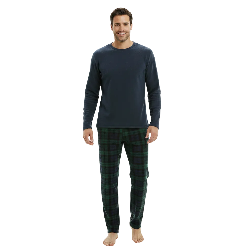 A man modeling a two-piece pajama set consisting of a dark navy long-sleeve shirt and green plaid pajama pants, standing against a plain white background.
