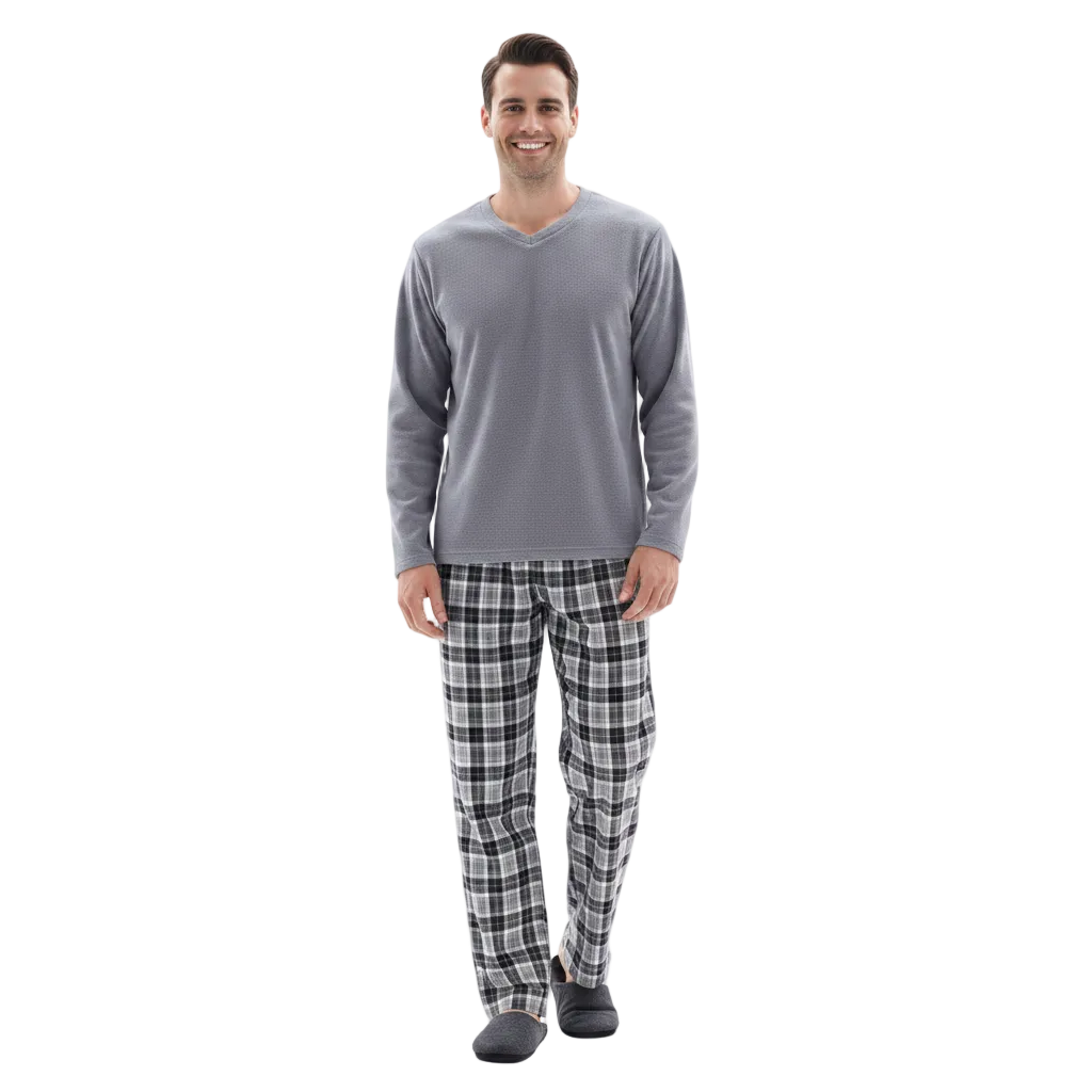 A man modeling a gray long-sleeve V-neck shirt and black-and-white plaid pajama pants with dark gray slippers, standing against a plain white background.