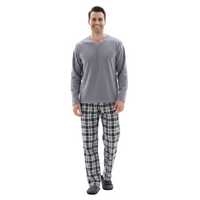 A man modeling a gray long-sleeve V-neck shirt and black-and-white plaid pajama pants with dark gray slippers, standing against a plain white background.