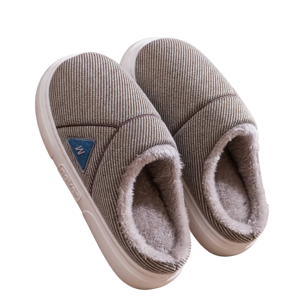 A pair of indoor slip-on slippers with a textured taupe-brown fabric upper, plush light gray lining, and a light beige sole, shown on a white background.