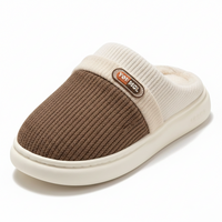 A single knit slip-on indoor shoe shown on a clean white background. The upper is brown knit with a cream ribbed collar and a small brown brand patch reading YOT-MG.