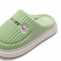 A light green ribbed fleece slipper with a plush lining, featuring a small embroidered pink bunny face and the text 'HAPPY LIFE' on the side, set against a clean white background.