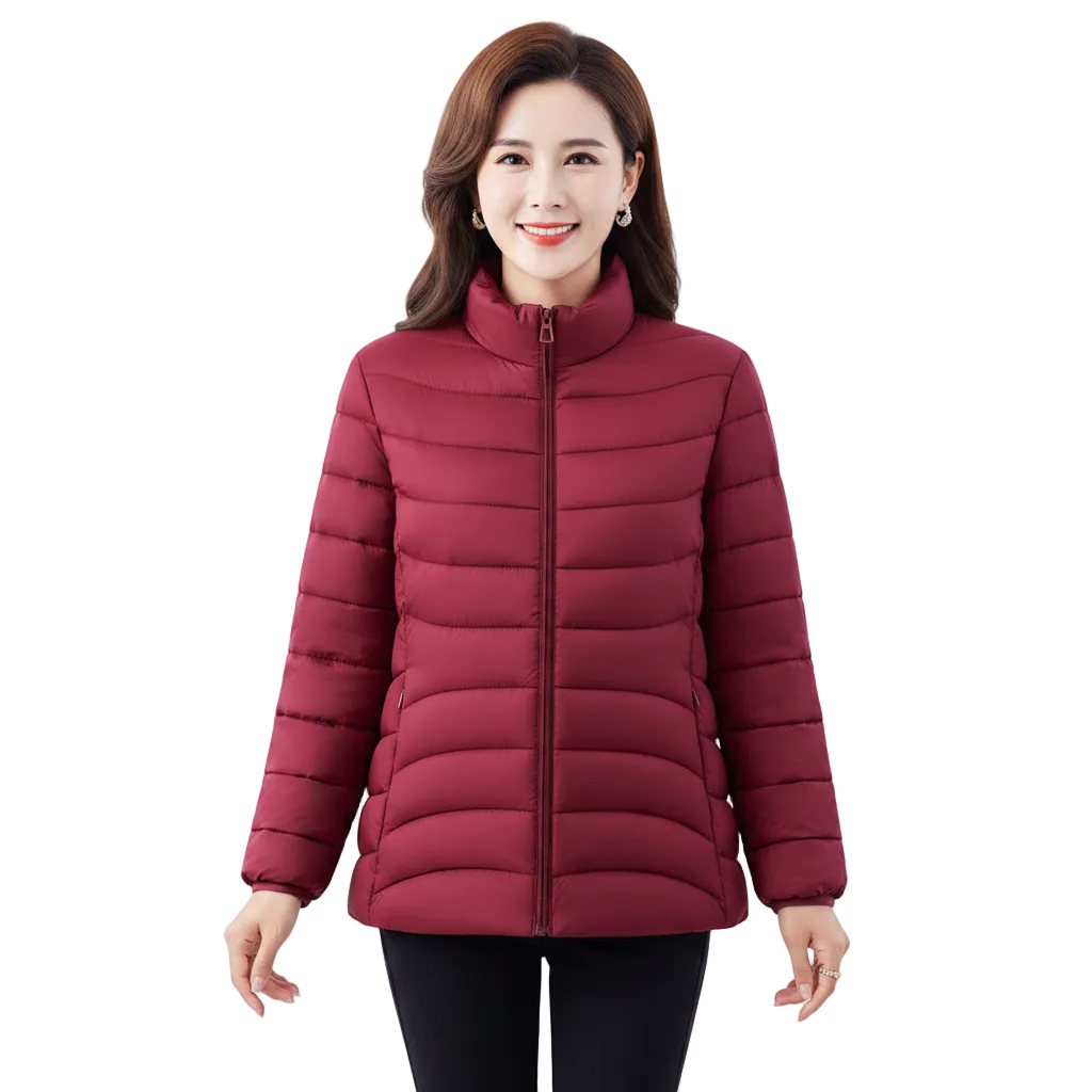 A woman wearing a quilted puffer jacket in a deep burgundy red color, paired with black pants, against a solid white background.