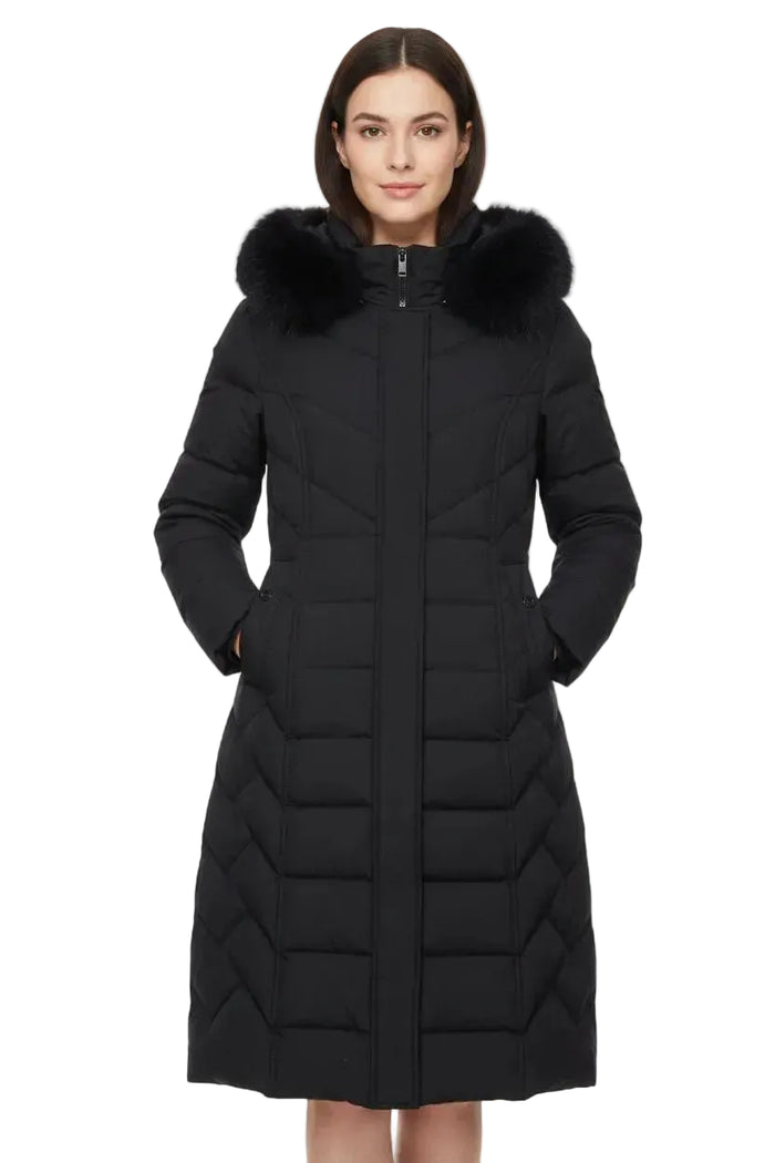A woman modeling a long black quilted winter coat with a plush black fur-trimmed hood, shown against a plain white background.