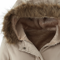 Close-up of a beige winter jacket with a plush faux-fur trimmed hood and matching faux-fur lining, shown against a plain white background.