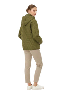 A woman wearing an olive green quilted hooded jacket, beige pants, and white sneakers, shown from a side-back angle against a plain white background.