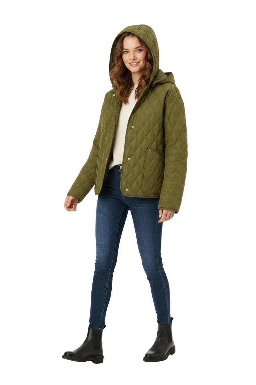 A woman modeling an olive green quilted hooded jacket, paired with a cream top, blue skinny jeans, and black ankle boots, against a plain white background.