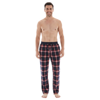 A man modeling a pair of plaid pajama pants against a plain white background. The pants feature a navy blue base with red and white plaid lines.