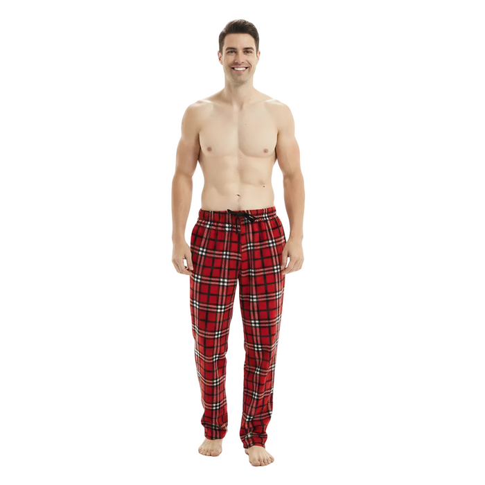 A man modeling red plaid pajama pants with black and white stripes, standing against a plain white studio background.
