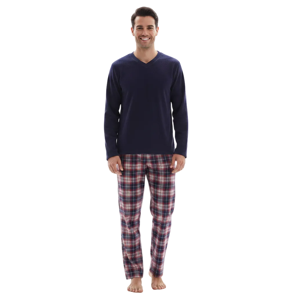 A man wearing a navy blue long-sleeve V-neck shirt and red, blue, and white plaid pajama pants, standing against a plain white background.
