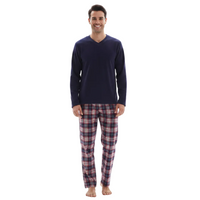 A man wearing a navy blue long-sleeve V-neck shirt and red, blue, and white plaid pajama pants, standing against a plain white background.