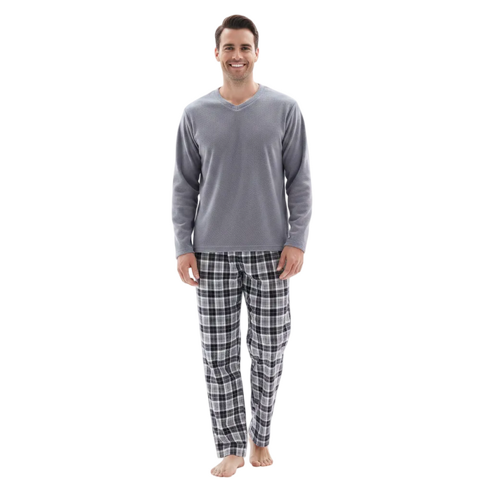 A man wearing a gray long-sleeve V-neck pajama top and black-and-white plaid pajama pants, standing against a plain white background.