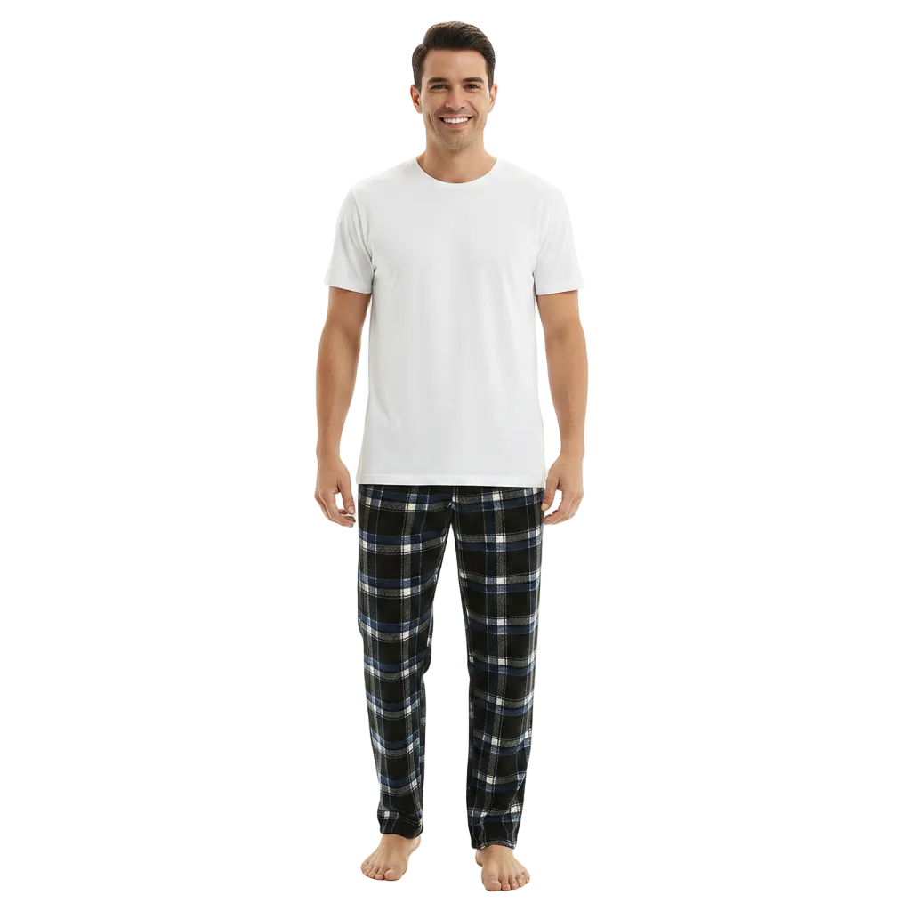 A man modeling a white crew-neck t-shirt and dark plaid pajama pants against a plain white studio background.