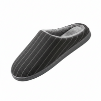 A single dark gray slip-on house slipper with thin white vertical pinstripes, a plush gray interior lining, and a dark gray sole, shown on a plain white background.