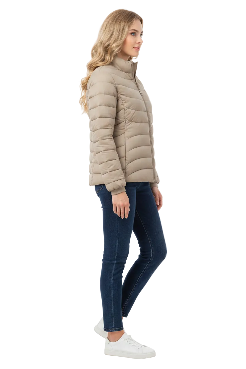 A woman modeling a light beige puffer jacket, paired with dark blue skinny jeans and white sneakers, shown in a side profile against a plain white studio background.