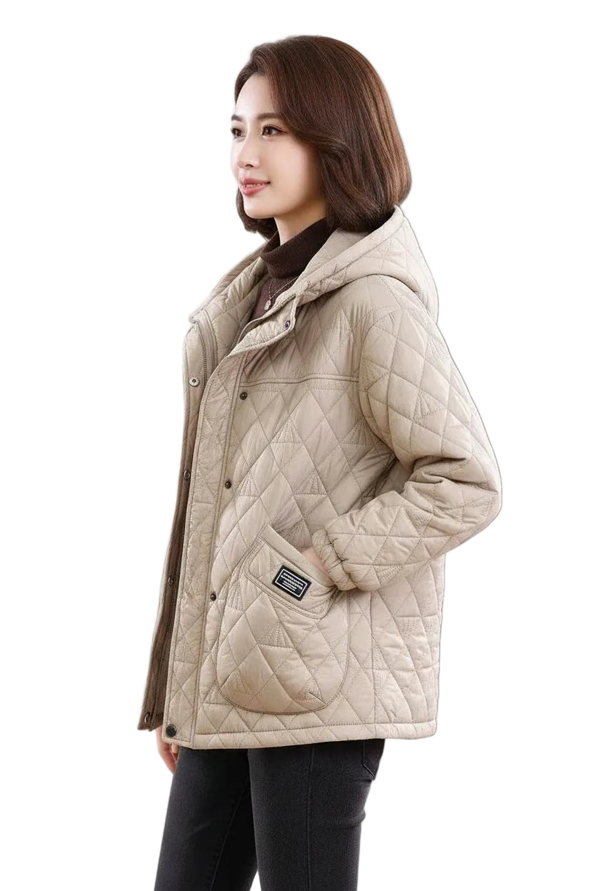 A woman wearing a beige quilted puffer jacket with a high collar, shown from the side against a plain white background.
