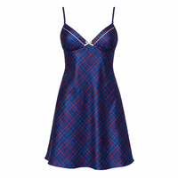 A satin slip dress with a blue, red, and navy tartan plaid pattern, featuring thin shoulder straps and a small silver bow at the center of the V-neckline, shown against a plain white background.