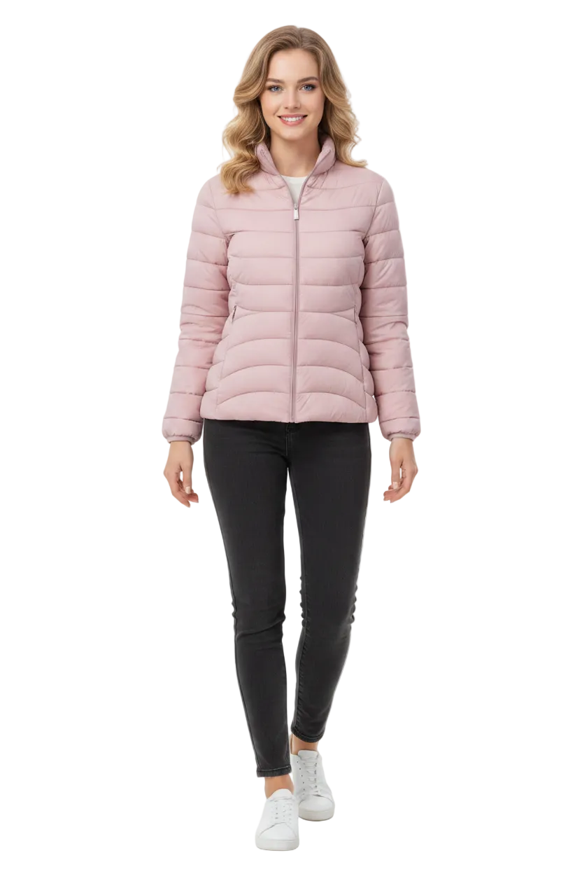 A woman modeling a light pink puffer jacket, paired with black skinny pants and white sneakers, against a plain white studio background.