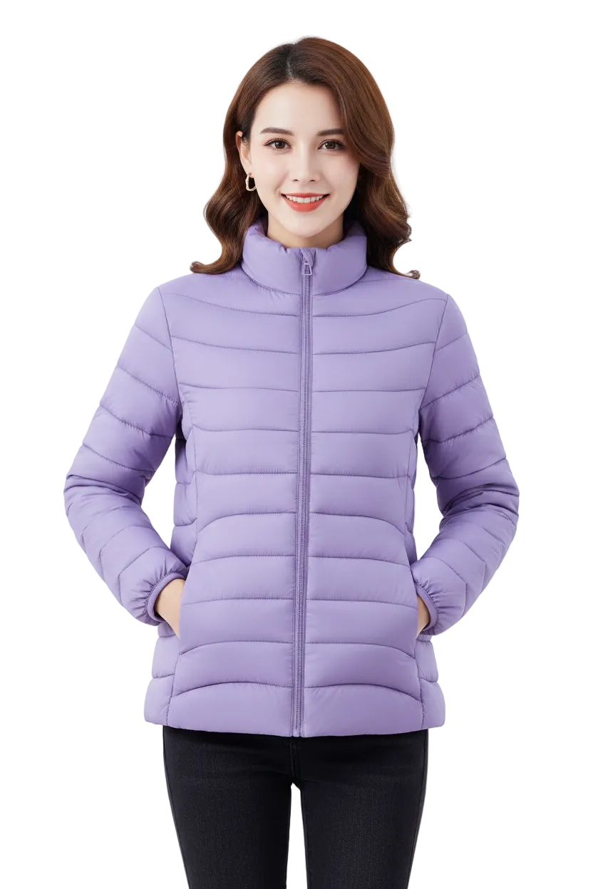 A woman modeling a light purple puffer jacket with a high collar and front zipper, paired with black pants, against a plain light gray background.