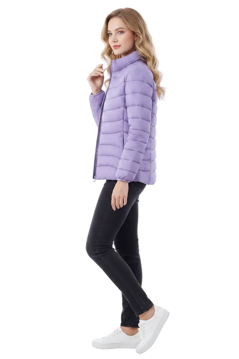 A woman modeling a light purple puffer jacket, paired with black skinny jeans and white sneakers, against a plain white studio background.