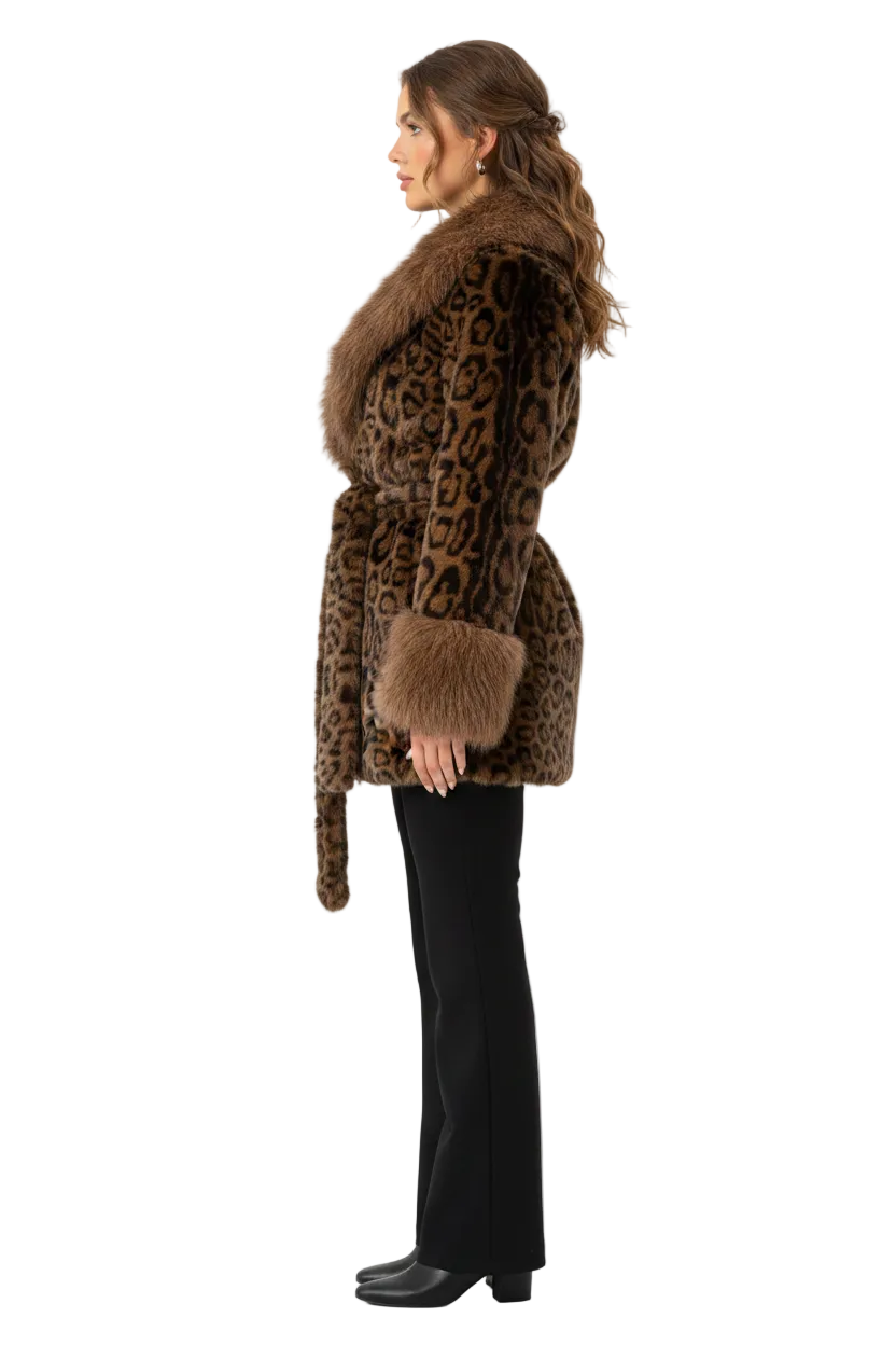 A woman shown in profile wearing a brown and black leopard-print faux fur coat with a matching fur collar, cuffs, and belt, paired with black pants and black shoes, against a plain white studio background.
